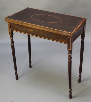 An Edwardian inlaid and crossbanded mahogany card table raised on turned and fluted supports 29"h x 28"w x 14"d 