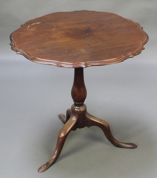A 19th Century circular mahogany wine table with pie crust edge raised on an associated pillar and tripod base 26" x 26"diam. 