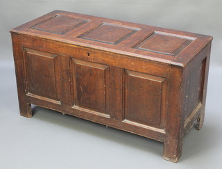 A 17th/18th Century oak coffer of panelled construction, the interior fitted a candle box 21"h x 40"w x 17"d 