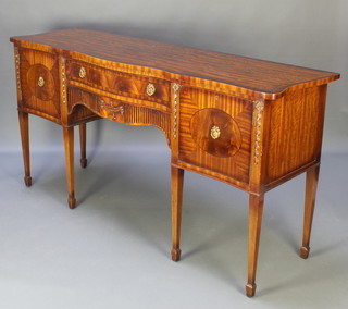A Georgian style mahogany sideboard of serpentine outline, fitted a drawer above a secret drawer flanked by a pair of cupboards enclosed by panelled doors, raised on 6 square tapered supports, spade feet 36"h x 71"w x 21"h 