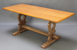 A light oak refectory style dining table, the top formed of 3 planks, raised on shaped standard end supports with H framed stretcher 29"h x 72"l x 30"w 
