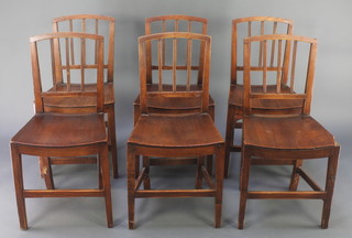 A set of 6 elm stick and rail back dining chairs with solid seats, raised on square tapering supports with cross framed stretcher 