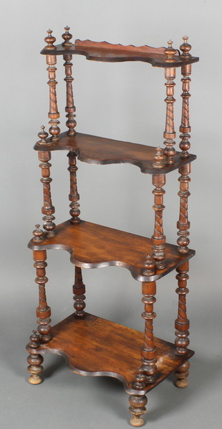 A Victorian mahogany 4 tier what-not of serpentine outline with spiral turned columns 46"h x 20"w x 13"d 