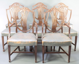 A set of 8 19th Century Hepplewhite style mahogany shield back dining chairs with Prince of Wales feathers and over stuffed seats, raised on square tapering supports ending in spade feet - 2 carvers, 6 standard 