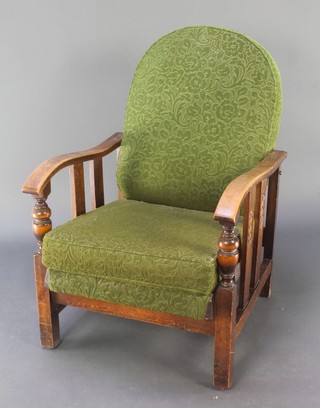 An Art Deco oak framed "Famulus patent" reclining armchair upholstered in green sculptured moquette 