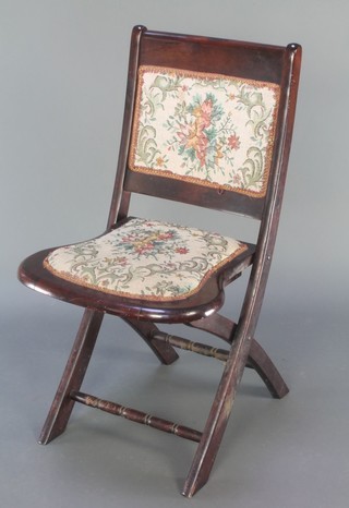 An Edwardian mahogany folding campaign chair with upholstered seat and back 