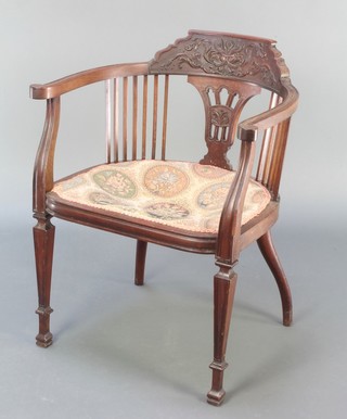 A Victorian carved walnut tub back chair with stick decoration and upholstered seat, raised on square tapered supports