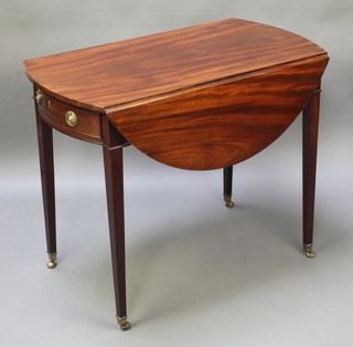 A 19th Century oval mahogany Pembroke table fitted a frieze drawer, raised on square supports ending in brass caps and castors 28"h x 35"w x 19" when closed x 39" when open 
