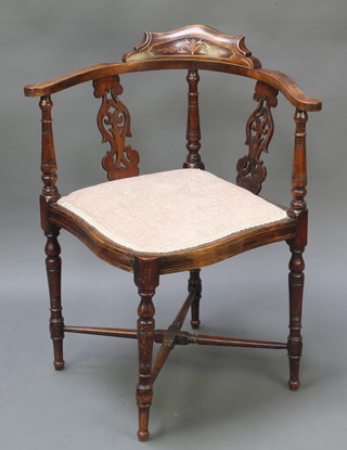 An Edwardian inlaid mahogany corner chair with pierced vase slat back and upholstered back raised on an X framed stretcher 