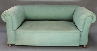 A pair of Edwardian drop arm Chesterfield settees upholstered in blue buttoned material 26"h x 57"w x 26"d 