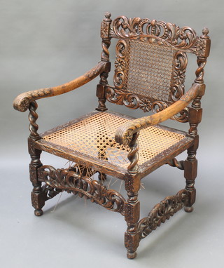 A Carolean style carved oak armchair with pierced and carved back and woven cane seat (f) 