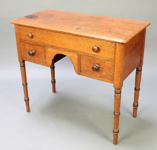 A Victorian oak side table fitted 1 long and 2 short drawers raised on ring turned supports 30"h x 35"w x 17 1/2"d 