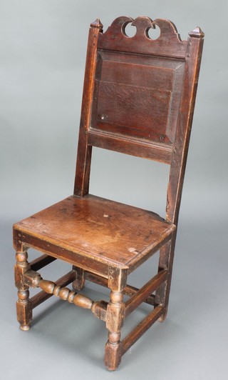 An 18th Century oak hall chair with solid seat and back raised on square supports with box framed stretcher 