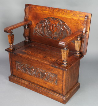 A carved oak monks bench with hinged lid, heavily carved throughout 29 1/2"h x 36"w x 19"d 