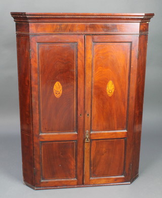 A Georgian inlaid mahogany corner cabinet with cornice, fitted shelves and 3 drawers to the base enclosed by panelled doors with shell motif 48"h x 36"w x 13"d 