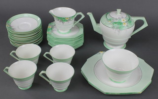 An Art Deco Paragon tea set decorated with spring flowers comprising teapot, 4 tea cups, 10 saucers, 11 plates, 2 sandwich plates, a sugar bowl and cream jug 
