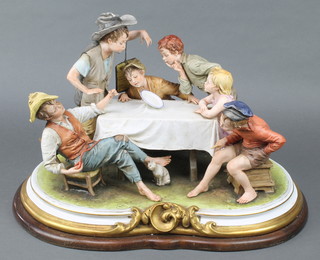 A large Capodimonte group of 6 children sitting around a table watching a magic trick, 20" 
