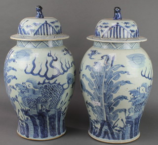 A pair of Chinese Provincial baluster vases and covers with shi shi finials and dragons amongst plants 21" 