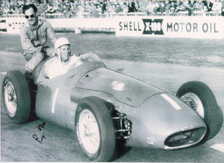 Sir Stirling Moss OBE and Archie Scott Brown, a photograph of the two with racing car, signed by Stirling Moss together with a slip of paper signed by Archie Scott Brown, framed 14" x 16"