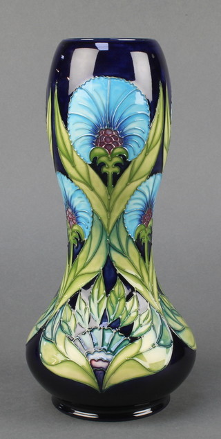 A contemporary Moorcroft waisted oviform vase, the blue ground with stylised flowers no.198/300 11", boxed 