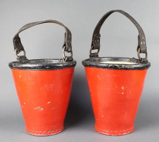 A pair of red and black painted leather fire buckets 11" x 10" diam. 