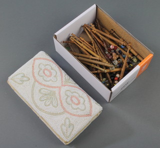 42 various turned wooden lace makers bobbins together with a rectangular bead work bag 4" x 7" 