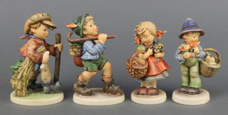 Four Hummel figures - girl with basket 355 5", boy with basket of chicks 378 5", boy with rucksack 327 6" and boy with cane 386 6" 