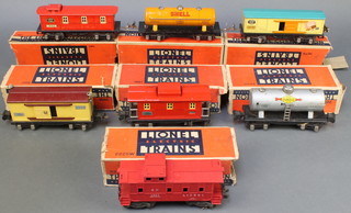 A Lionel Corporation tin plate model no. 1679 box car, do. no. 1680 oil car, do. 1682 Caboose boxed together with 3 other items of rolling stock no. 2655, 2657, 2257 and 2654 - partially boxed 