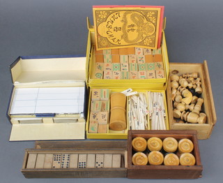 A turned wood St George's pattern chess set, a set of turned wooden draughts, a set of wooden dominoes, a bamboo Mahjong set with ivory counters and a bridge set 