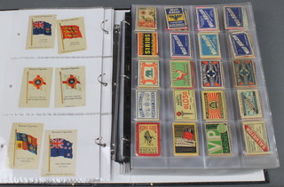 An album containing 54 Kensitas silks of flags and 280 matchbox covers 