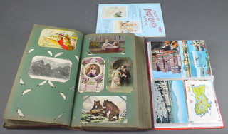 An orange album of postcards and an 1983 edition of "The Picture Postcard Annual"
