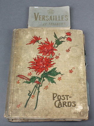 An album of coloured and black and white postcards and a small album of postcards of Versailles 