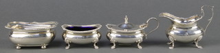 A Victorian silver cream jug with shell rim on paw feet Birmingham 1900, a ditto mustard, salt and bowl 290 grams 
