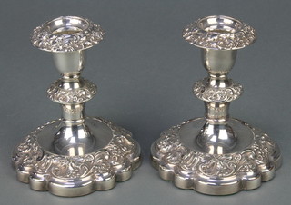A pair of silver plated repousse candlesticks 6" 