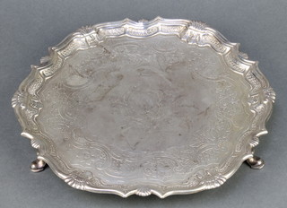 A George II silver salver with chased floral and scroll decoration on pad feet 10 1/2", maker Robert Abercromby, London 1745