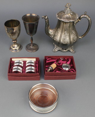 A silver plated coaster, 2 ditto cups, a teapot and 2 cased sets
