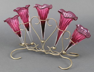 An Edwardian silver plated 5 section epergne with cranberry glass flutes on a wire work base 
