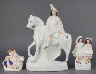 A Victorian Staffordshire figure of a Scotsman on horseback 14 1/2", a ditto of a Scottish couple 7 1/2" and a spill vase with a reclining dog and gentleman 4" 
