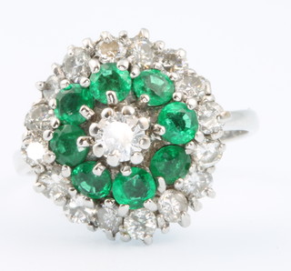 An 18ct white gold emerald and diamond cluster ring, size M 