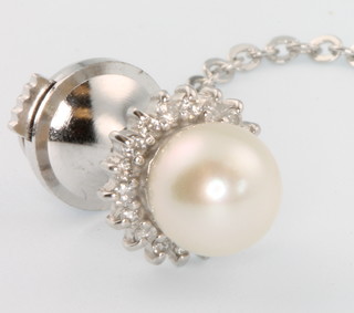 A white gold pearl and diamond tie pin with steel back 