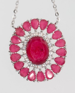 A silver and pink pendant and chain 