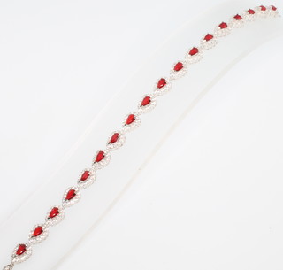 A silver red and and white cubic zirconia line bracelet 