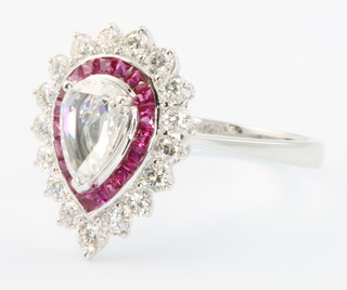 An 18ct white gold pear shaped diamond and ruby ring, the centre diamond approx. 0.52ct surrounded by brilliant cut rubies approx. 0.66ct and brilliant cut diamonds 0.65ct, size O