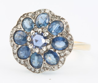 A 15ct yellow gold sapphire and diamond cluster ring size L