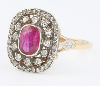 A yellow gold ruby and diamond Edwardian style ring, the centre stone approx 0.8ct surrounded by brilliant cut diamonds approx. 0.40ct size O 1/2