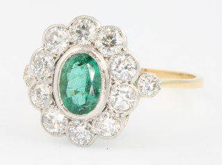 An 18ct yellow gold emerald and diamond cluster ring size O