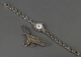 A silver and marcasite lady's wristwatch and silver and marcasite brooch in the form of an eagle 54 grams