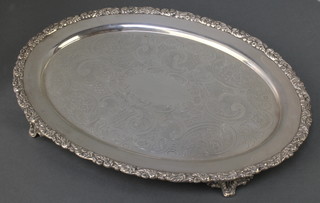 A Victorian silver oval tray with floral rim, the centre engraved with scrolls and flowers, William Hutton and Sons London 1899, 16", 1116 grams 