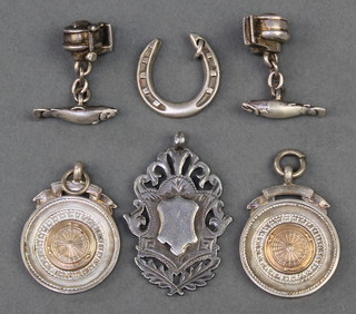 A pair of silver novelty cufflinks in the form of fish and fishing reels, 3 fobs and a horseshoe medallion 49 grams 