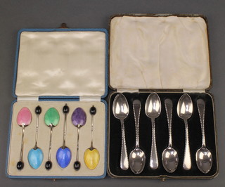 A set of 6 silver teaspoons Birmingham 1933 cased and 6 silver guilloche and enamel coffee spoons with bean ends Birmingham 1932 